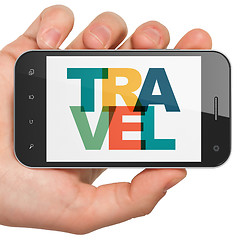 Image showing Holiday concept: Hand Holding Smartphone with Travel on  display