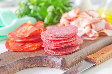 Image showing salami,ham and bacon on wooden board
