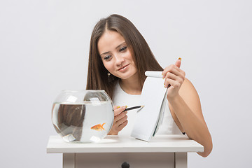 Image showing She asks goldfish desire to the bookmark