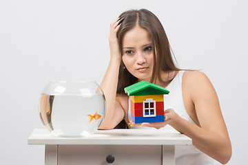 Image showing A girl asks her house goldfish