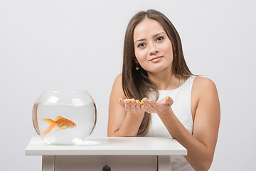 Image showing She asks to fulfill the desire to have a goldfish in an aquarium