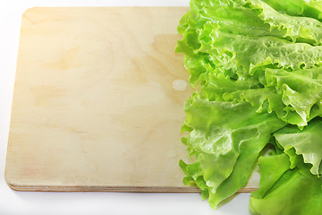 Image showing Lettuce lying on wooden 