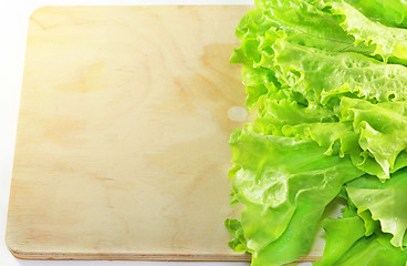 Image showing Lettuce lying on wooden 