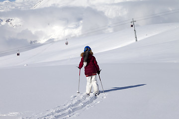 Image showing Girl on skis in off-piste slope with new fallen snow at nice day