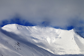 Image showing View on sunlight evening off-piste slope in mist