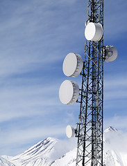 Image showing Satellite dishes in snowy mountains at sun day