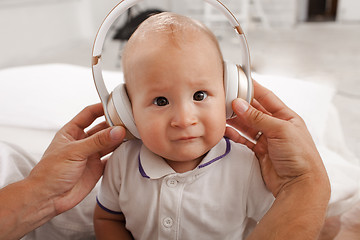 Image showing baby with headphones listening to music