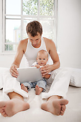 Image showing Young father and his nine months old son with digital tablet