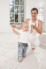 Image showing young father with his nine months old son at home