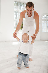 Image showing young father with his nine months old son at home