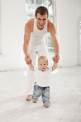 Image showing young father with his nine months old son at home