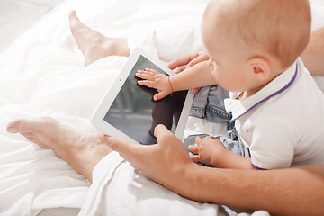 Image showing Young father and his nine months old son with digital tablet