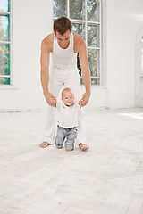 Image showing young father with his nine months old son at home