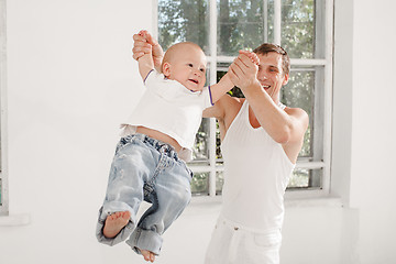 Image showing young father with his nine months old son at home