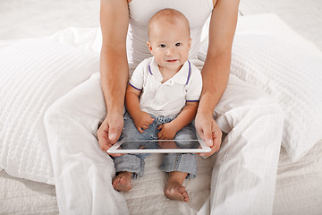 Image showing Young father and his nine months old son with digital tablet