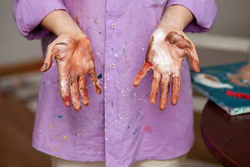 Image showing The girl with painted hands