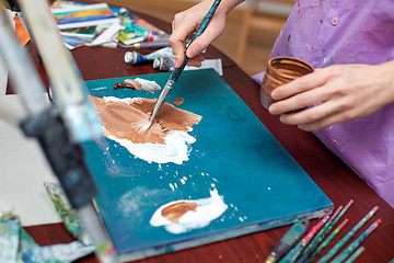 Image showing Artist\'s hands close-up on the background of palette 