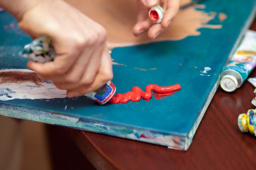 Image showing Artist\'s hands close-up on the background of palette 