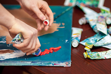 Image showing Artist\'s hands close-up on the background of palette 