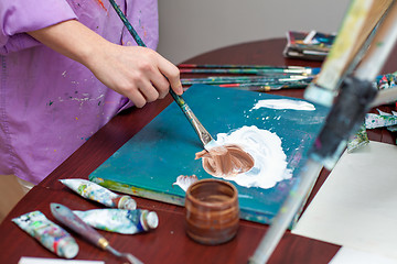 Image showing Artist\'s hand close-up on the background of palette 