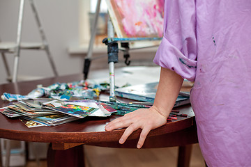 Image showing Artist\'s hand close-up on the background of palette 