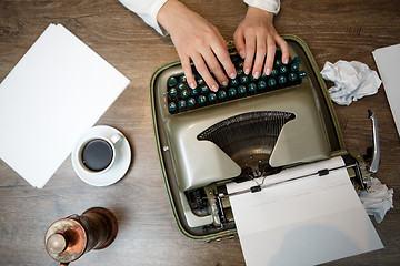 Image showing Hands on typing machine