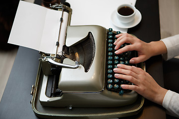 Image showing Hands writing on typewriter