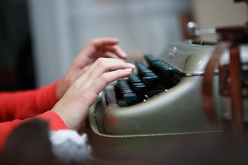 Image showing Hands of a man typing on typewriter