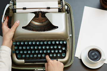 Image showing closeup of coffee and hands writing