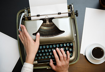 Image showing closeup of coffee and hands writing