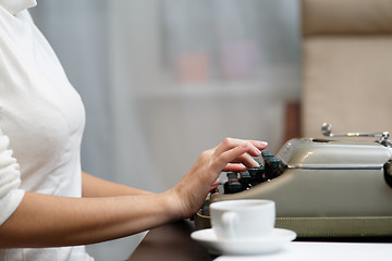 Image showing Hands writing on typewriter