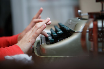 Image showing Hands of a man typing on typewriter