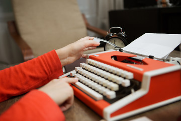 Image showing Vintage red typewriter with blank paper