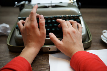 Image showing woman typing on old typewriter