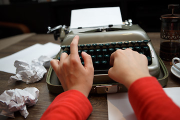 Image showing woman typing on old typewriter