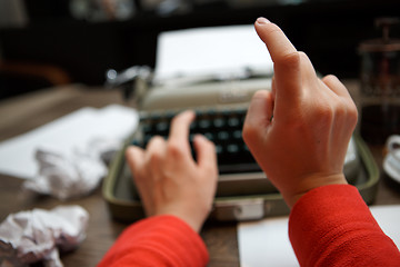 Image showing woman typing on old typewriter