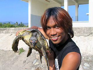 Image showing Boy holding sea turtle