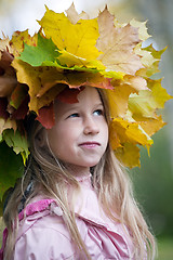 Image showing funny smiling girl in maple leaves wreath on her head