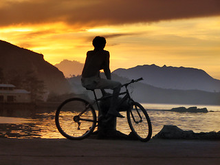 Image showing Biker boy silhouette in sunset