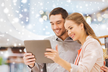 Image showing happy couple with tablet pc taking selfie in mall