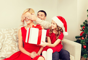 Image showing father and daughter surprise mother with gift box