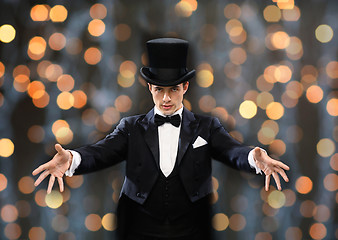 Image showing magician in top hat showing trick
