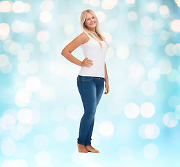 Image showing smiling young woman in blank white shirt and jeans