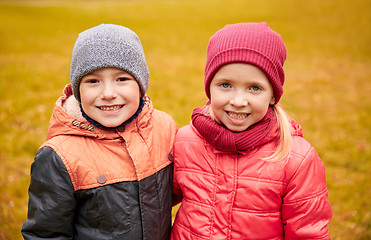 Image showing happy little girl and boy in autumn park