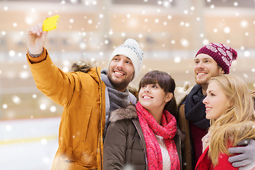 Image showing happy friends taking selfie on skating rink