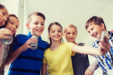 Image showing group of school kids with smartphone and soda cans