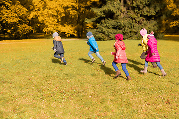 Image showing group of happy little kids running outdoors