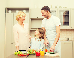 Image showing happy family making dinner in kitchen