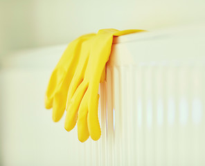 Image showing close up of rubber gloves hanging on heater