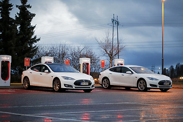 Image showing Two Tesla Model S Cars Plugged in at Supercharger Station